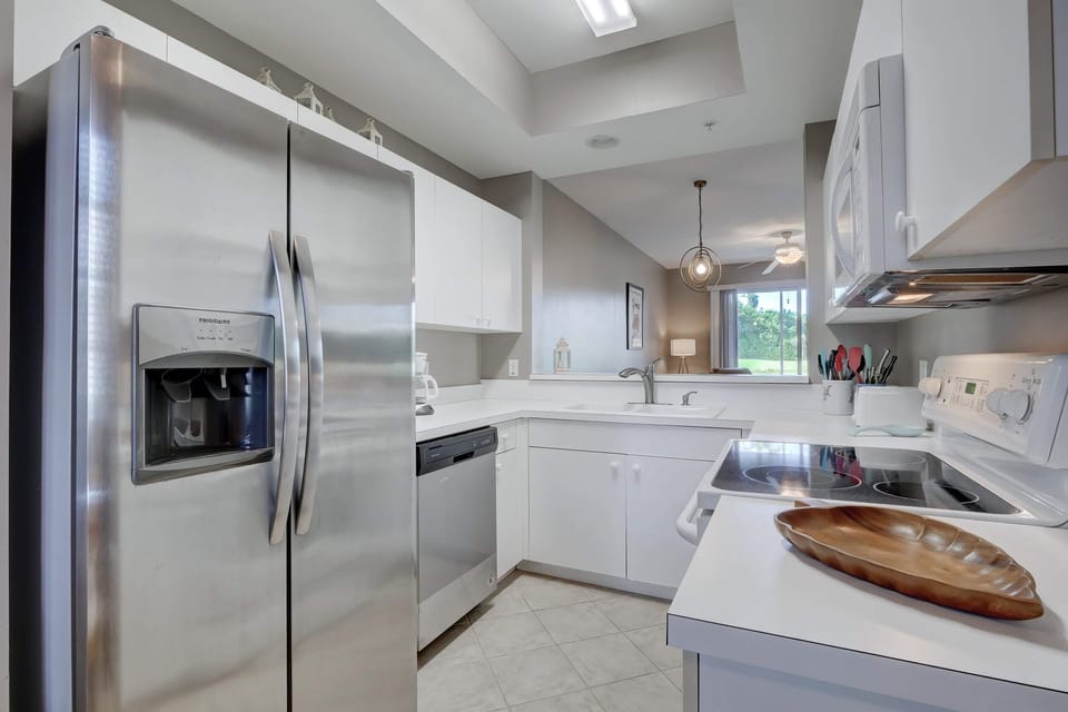 The Kitchen of the Condo Has Lots of Lighting