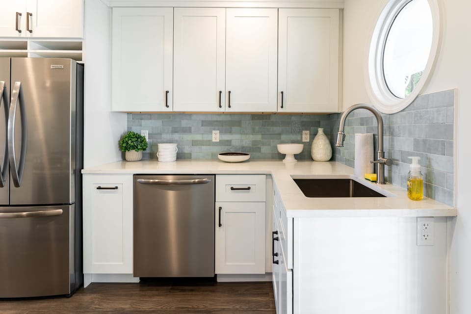 Dishwasher, sink, and fridge/freezer.