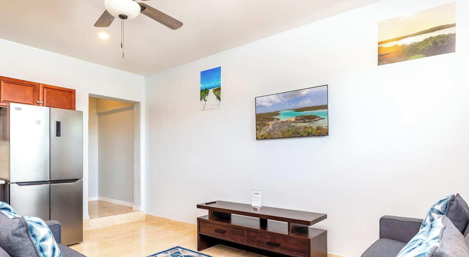 Relax in style in this cozy living area, featuring plush seating and a tasteful design.