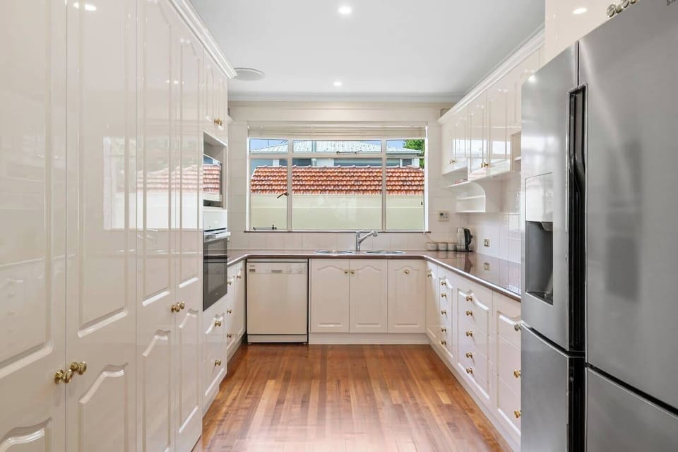 An inviting kitchen comes well equipped for your holiday catering at home including ample prep space and a large fridge. 