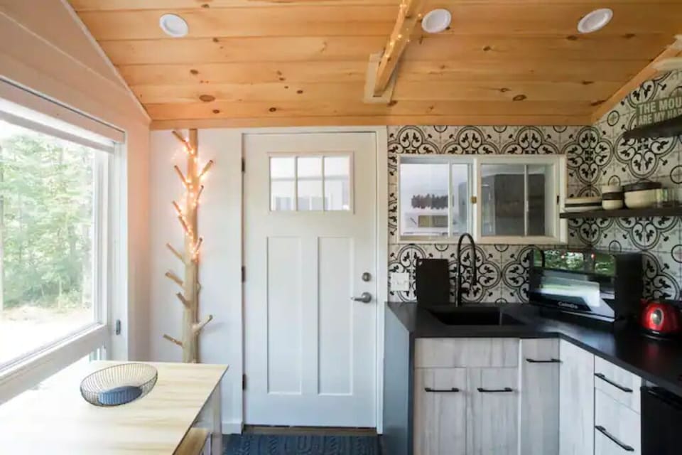 Front door, kitchen table for 4 with bench seats and a coat tree.