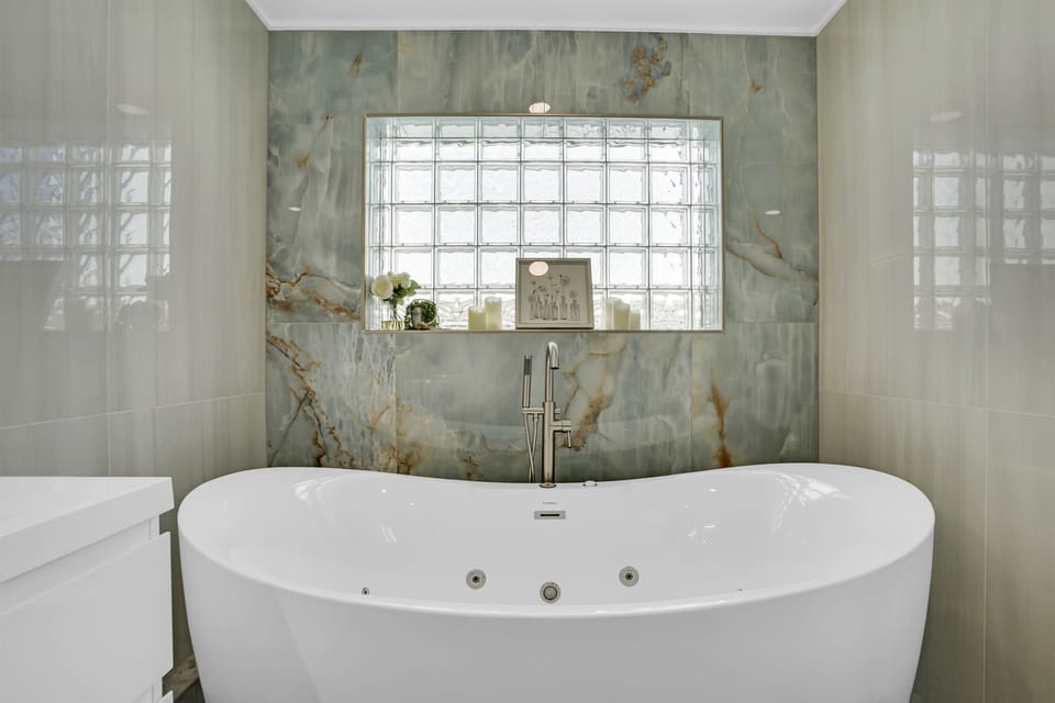Ensuite bath with soaking tub and full shower—spa vibes included.