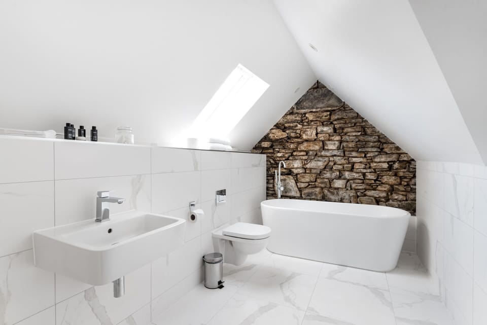 Loft Suite | Bathroom | Designer toiletries, hair dryer, bathrobes, slippers