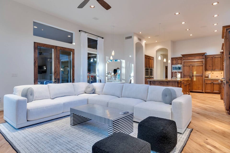 Family room with large sectional sofa, 75" Smart TV w/ Youtube TV Live & gas fireplace
