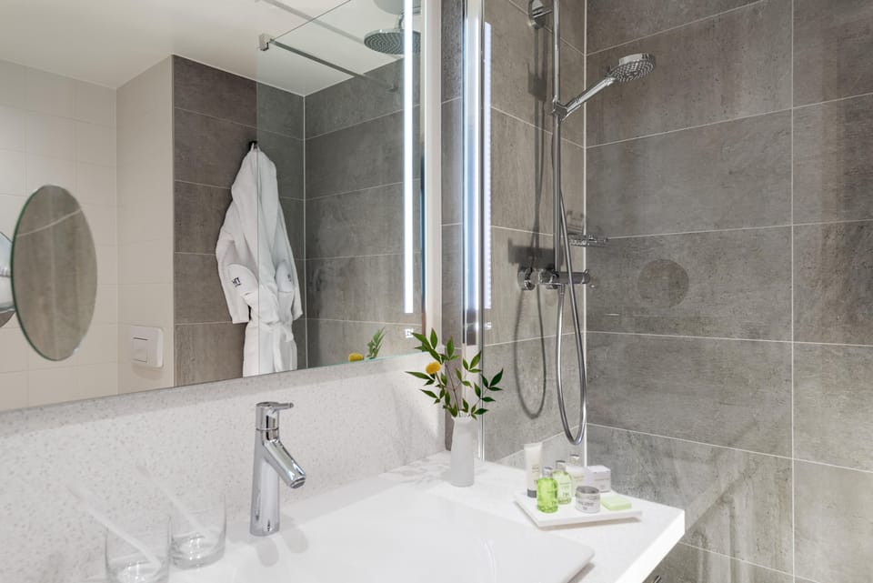 Deep soaking tub, rainfall showerhead, eco-friendly toiletries