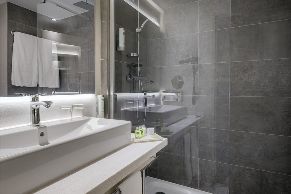 Deep soaking tub, rainfall showerhead, eco-friendly toiletries