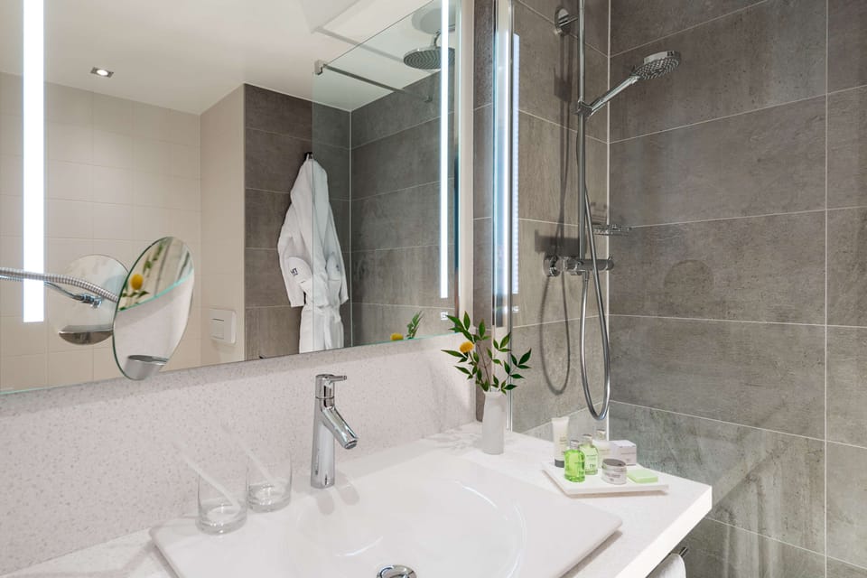 Deep soaking tub, rainfall showerhead, eco-friendly toiletries