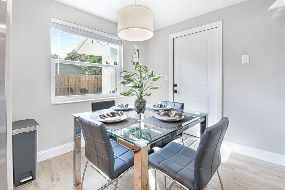 Dining room with seating for 4 people and 3 people can sit at the island/bar