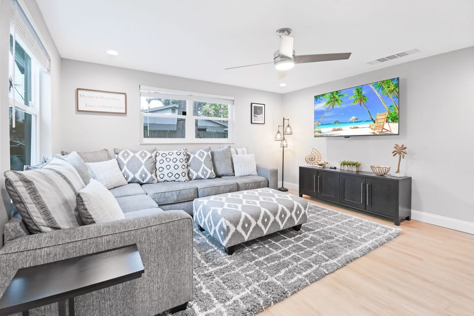 Living room features a 65" Smart TV along with a Roku & a very comfortable couch