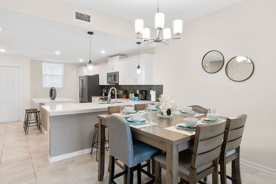 Modern open concept of living room, dining room and kitchen with island!#Disney #Parks #kingdom #springs #StoreyLake #Apartment #Vacation #Rental #waterpark #Kissimmee #Orlando #universal #citywalk