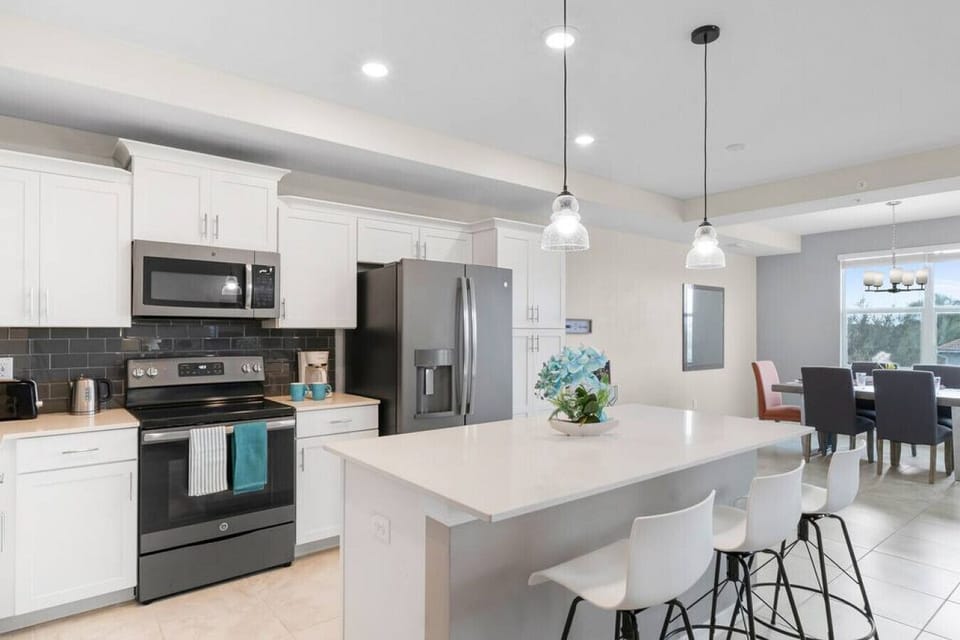 Kitchen & Island with pendant lights!#Disney #Parks #kingdom #springs #StoreyLake #Apartment #Vacation #Rental #waterpark #Kissimmee #Orlando #universal #citywalk