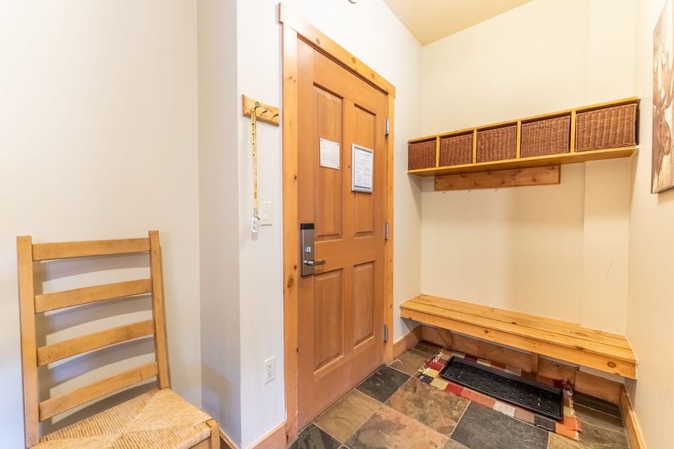 Your private entryway welcomes you with warm wood tones and thoughtful storage—hang your coat, slip off your shoes, and settle into comfort.