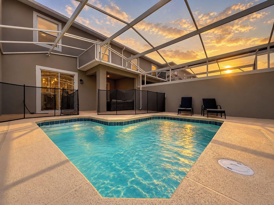 Private Screened Pool Deck with Loungers at Sunset