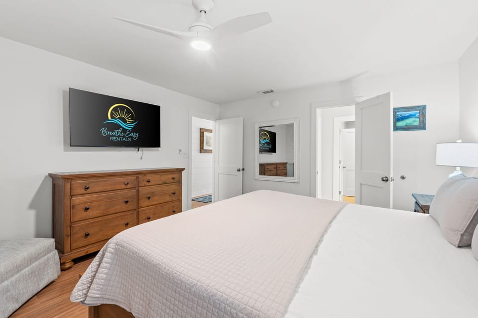 Relax in the master suite with a comfy king bed, fresh linens, and a cozy coverlet. Batthroom accessible from bedroom.