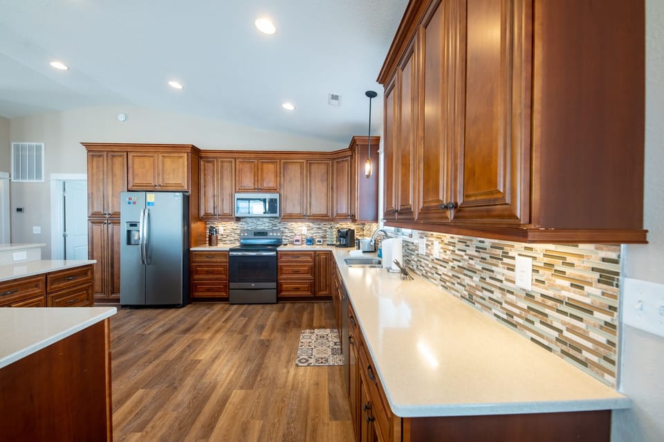 Kitchen has plenty of counter space for preparing a home cooked meal...