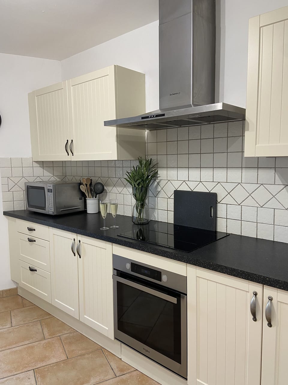Kitchen features full oven, hob, microwave and fridge/freezer.