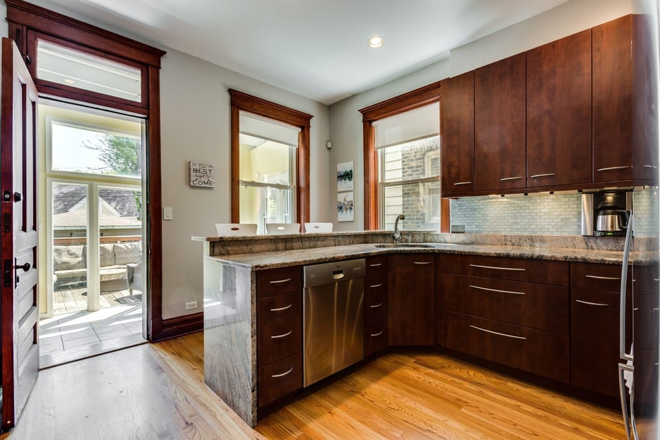 Just off the kitchen is an enclosed porch and access to a patio shared by the whole building