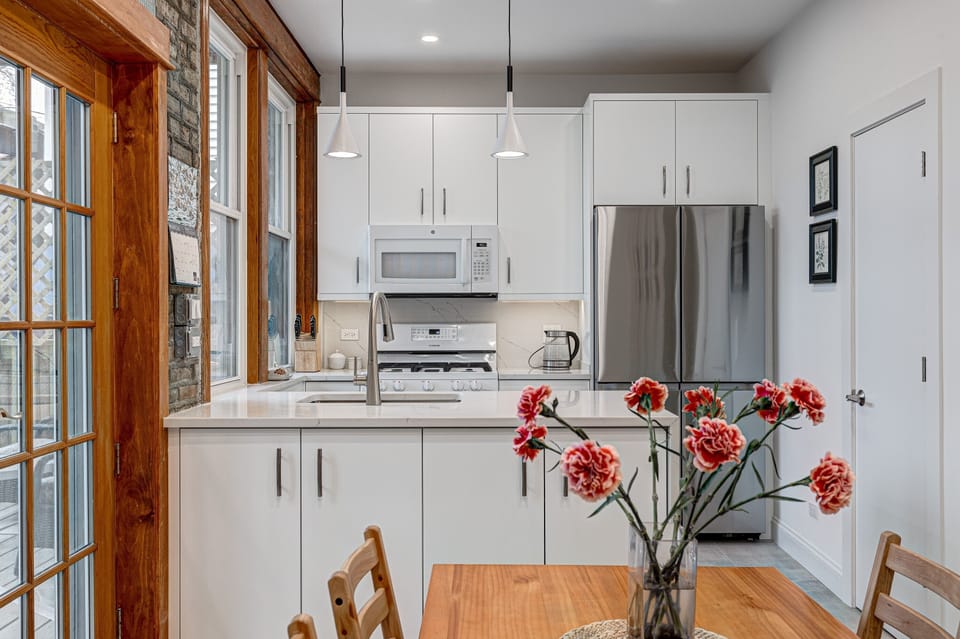 At the rear of the main floor is our kitchen, which we recently fully remodeled and updated with brand new appliances, cabinets, and finishes, while keeping the vintage charm of our home intact!