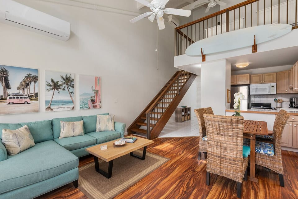 Airy open-plan living room w/ loft above & comfy seating for relaxed hangs.