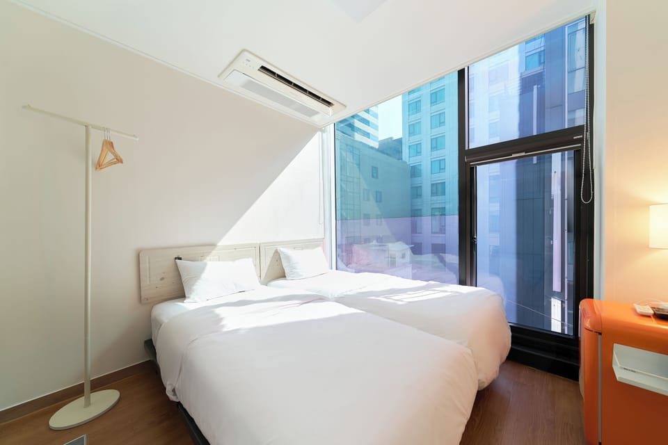 Economy Twin Room, 2 Twin Beds, Non-Smoking | Individually decorated, laptop workspace, blackout drapes, soundproofing