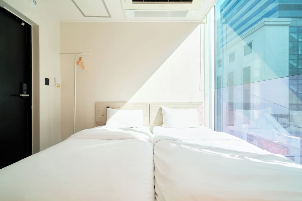 Economy Twin Room, 2 Twin Beds, Non-Smoking | Individually decorated, laptop workspace, blackout drapes, soundproofing