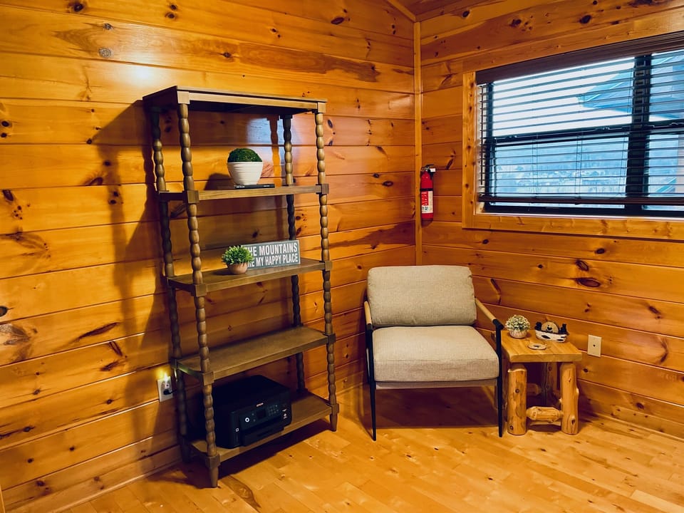 Office Space with a seating area for reading and relaxing. Printer and bookcase to place work-related items.