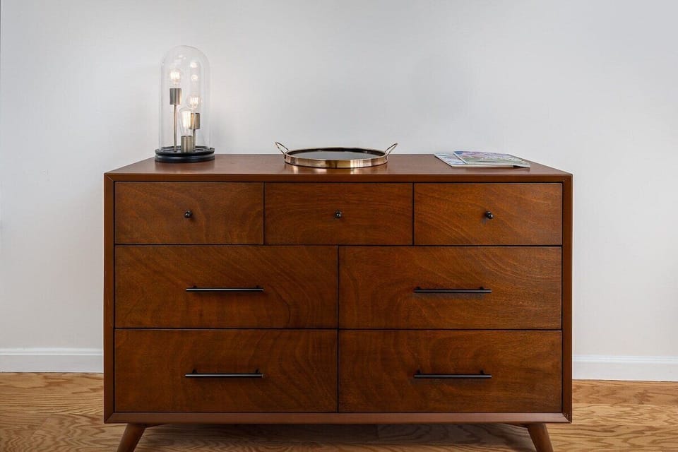 The master bedroom features a large dresser and two walk in closets.