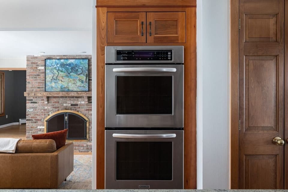 The kitchen features a double oven and connects to the Living Room.