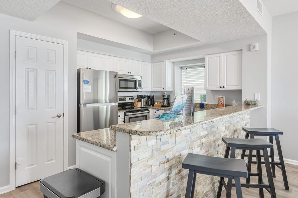 Fully remodeled kitchen with granite countertops, stainless appliances, and fully stocked so you can prepare meals in your home away from home!
