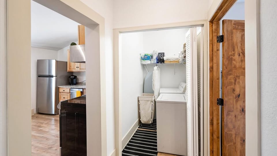 The laundry room features a washer and dryer and lots of storage!