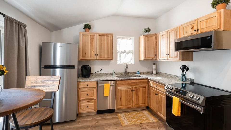 The large kitchen is fully stocked with cookware and top of the line appliances. The kitchen also features a cozy coffee nook with seating for two.