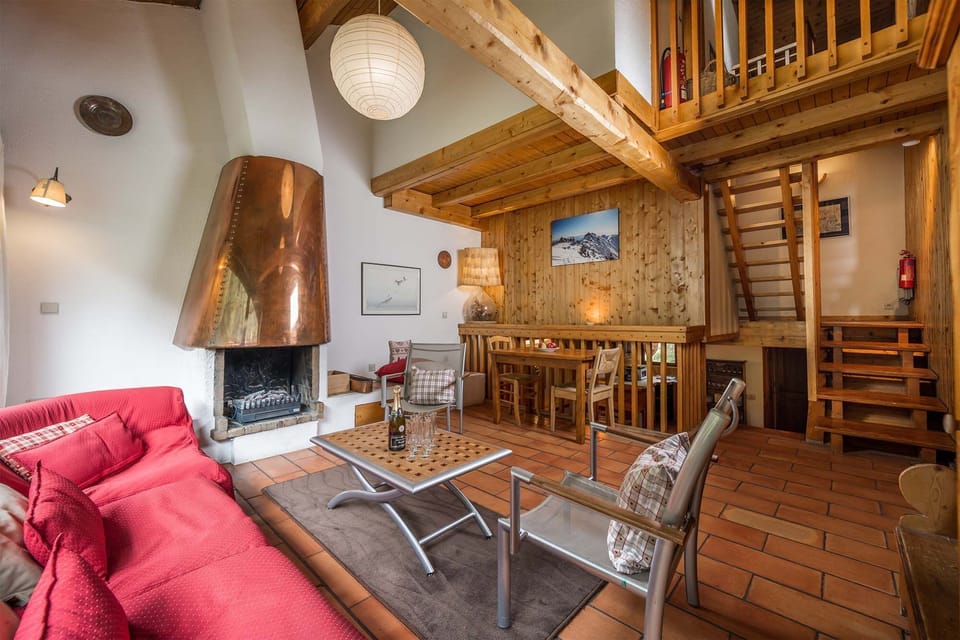 The cozy living area features a wood-burning fireplace.