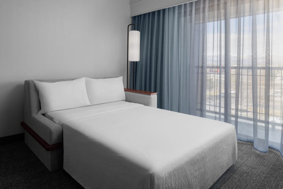 Premium bedding, desk, laptop workspace, iron/ironing board