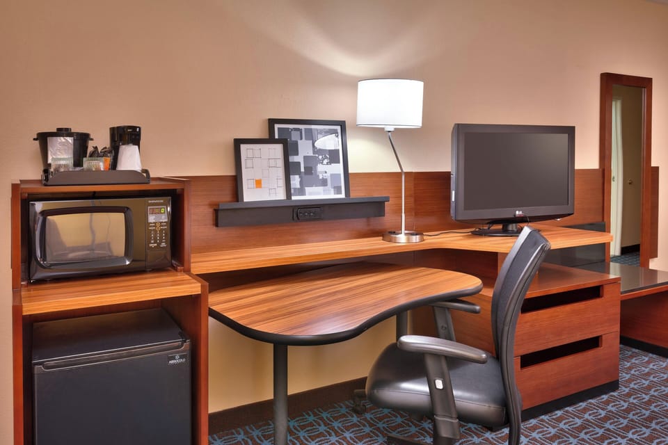 Premium bedding, desk, laptop workspace, iron/ironing board