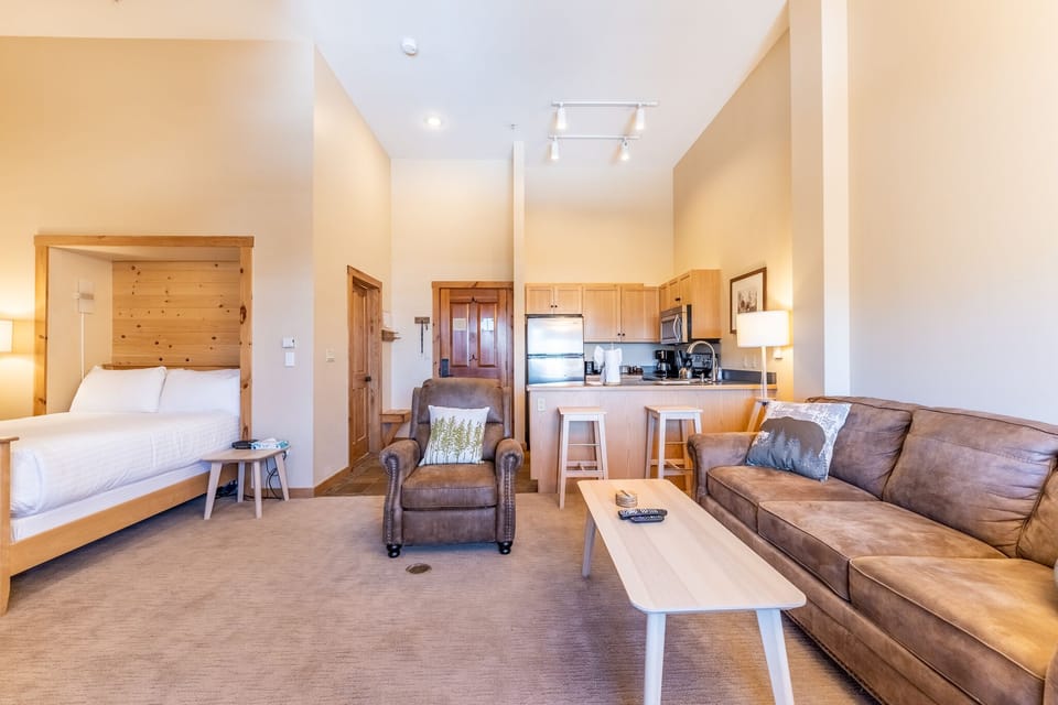 Unwind in this thoughtfully designed open-concept space where rustic wood meets modern comfort, perfect for relaxing after mountain adventures.
