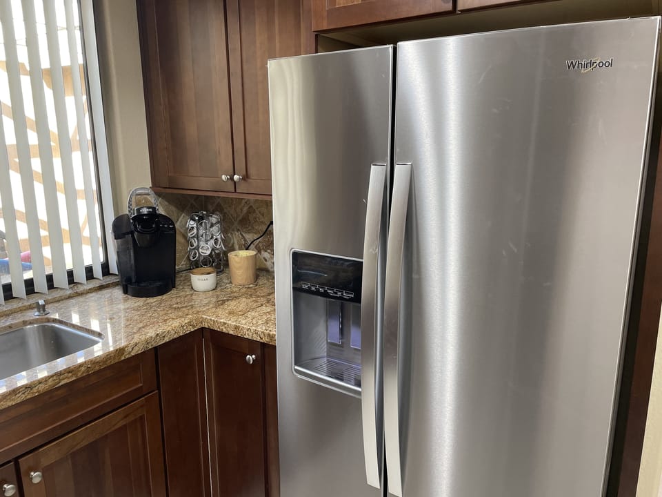 Kitchen view refrigerator and coffee bar 