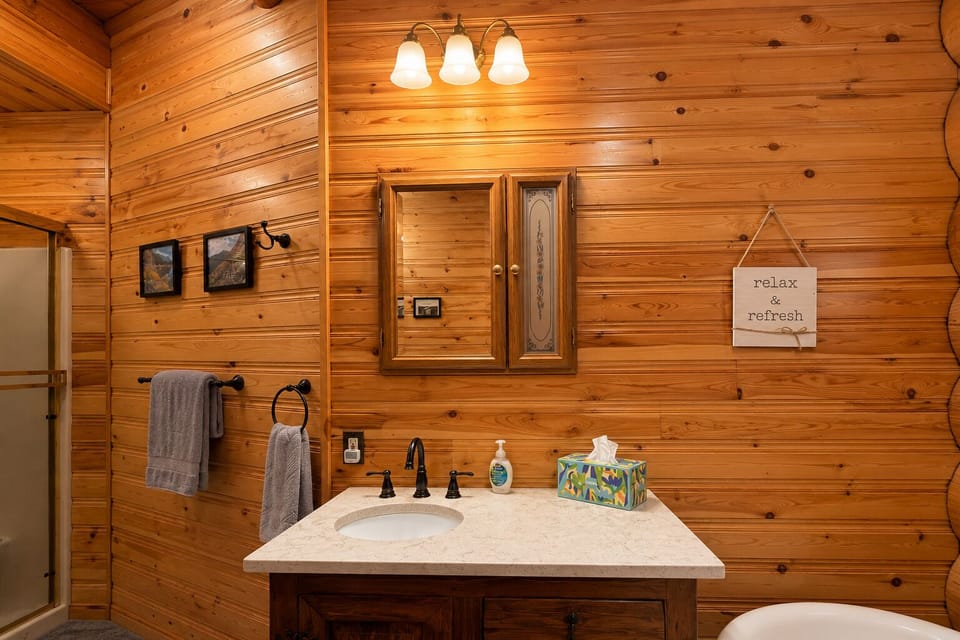 Vanity in the lower level full bathroom space includes towels and hair dryer