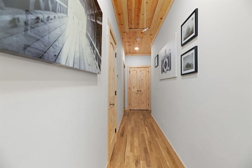 Hallway: Stylish wooden finishes and artfully framed photos guide you to your adventure!