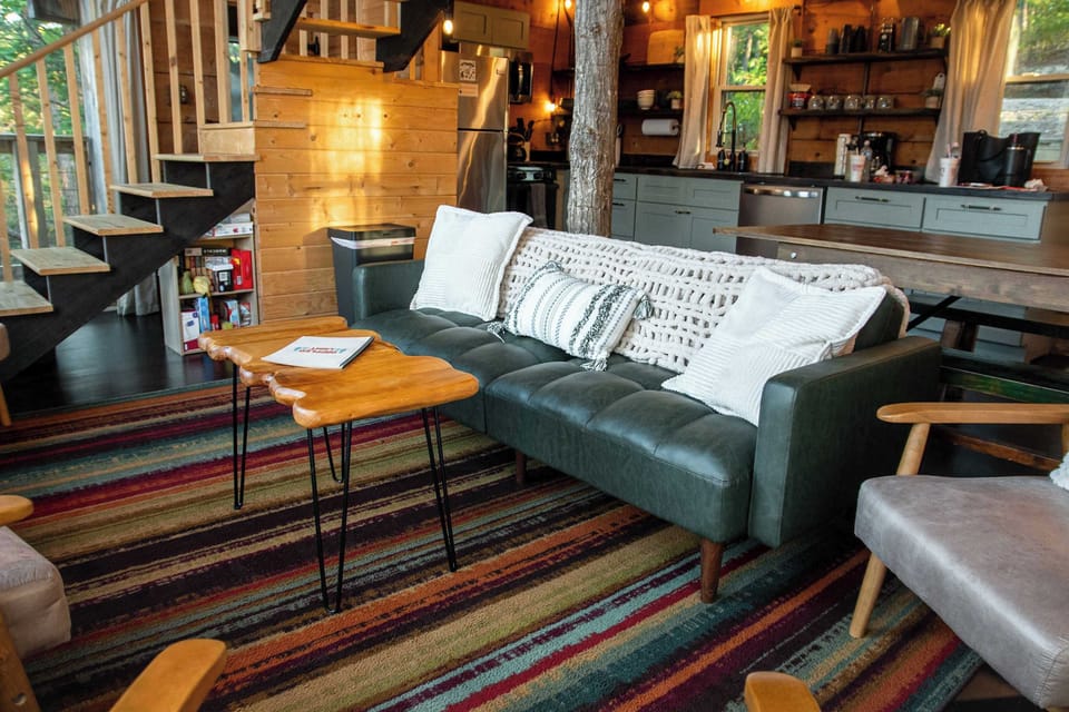 Living room with a couch and a few arm chairs. No TV or wifi - the perfect place to unplug and relax!