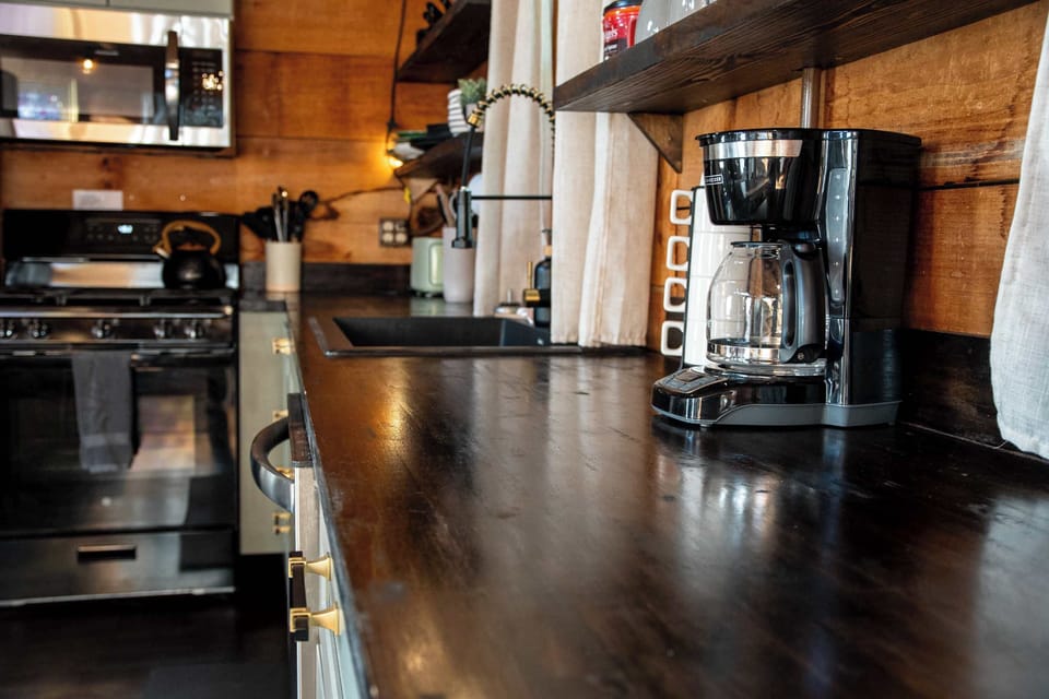 Equipped with a coffee pot, coffee filters, and coffee grounds.