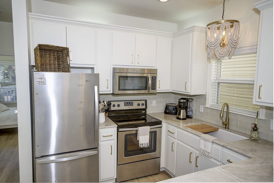 Newly renovated kitchen featuring Taj Mahal counter tops.   