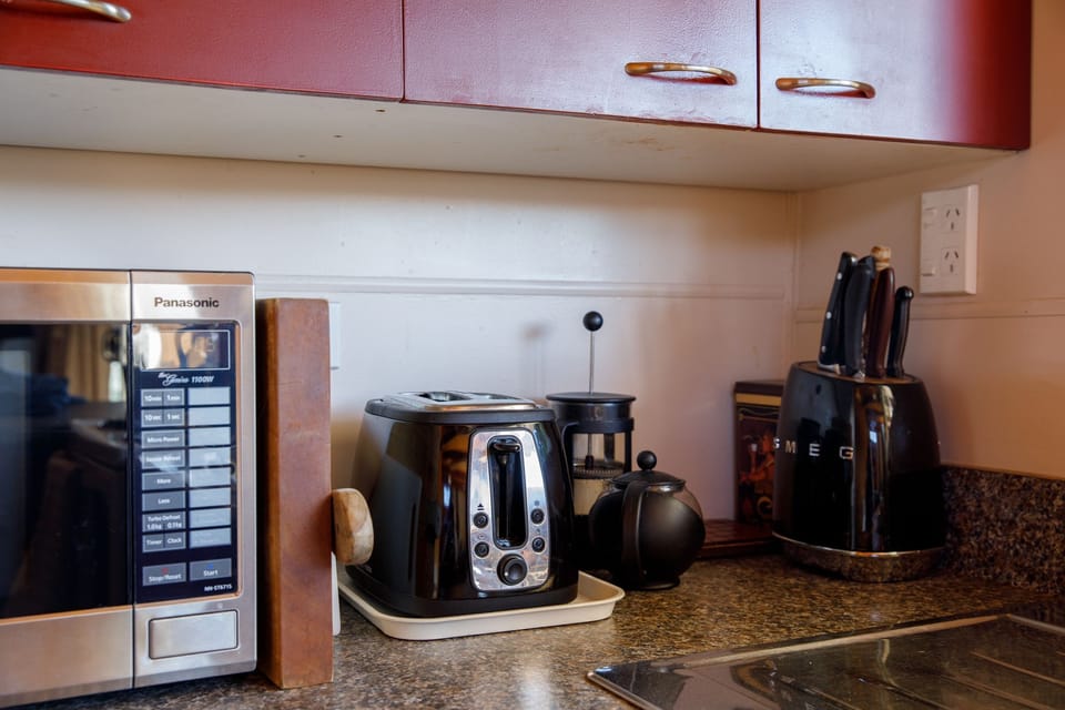 Microwave, toaster, tea pot, coffee plunger, knife block