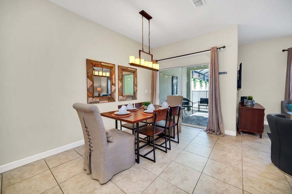 The dining room perfectly integrates with the rest of the house, as well as the outside area with BBQ grill and pool.