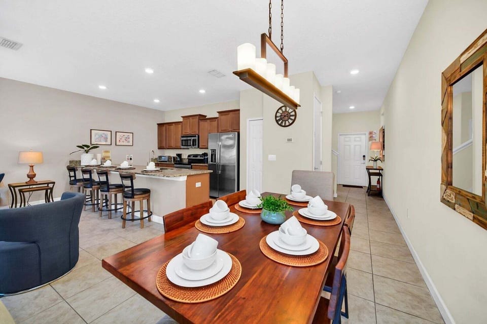 The dining area comfortably seats 6 people, with 4 additional stools at the kitchen bar.