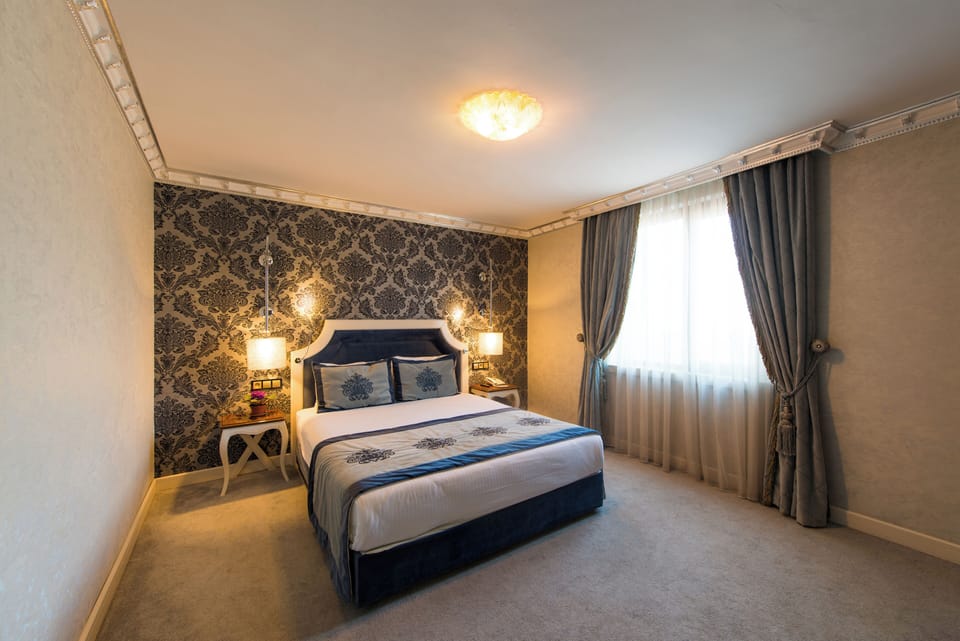 Deluxe Room | Premium bedding, minibar, in-room safe, individually decorated