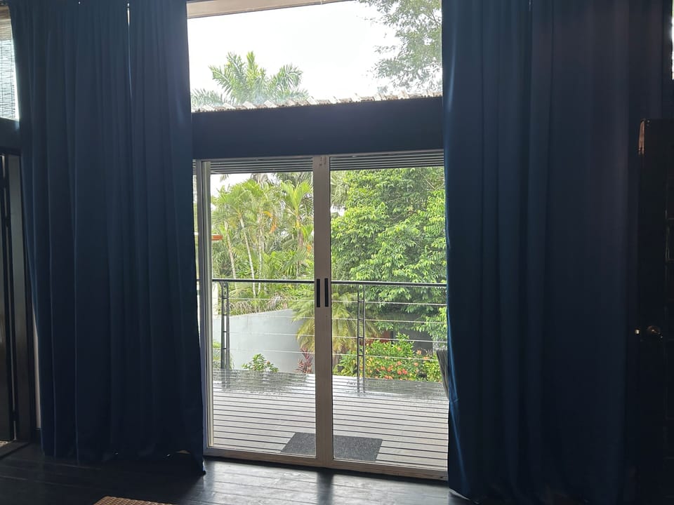 Primary w balcony access overlooks the pool