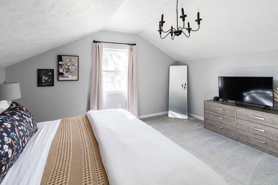 The 3rd upstairs bedroom has a king bed, dual end tables, device chargers, and SmartTV.