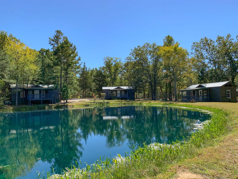Three deluxe Kozy Kabins facing pond.