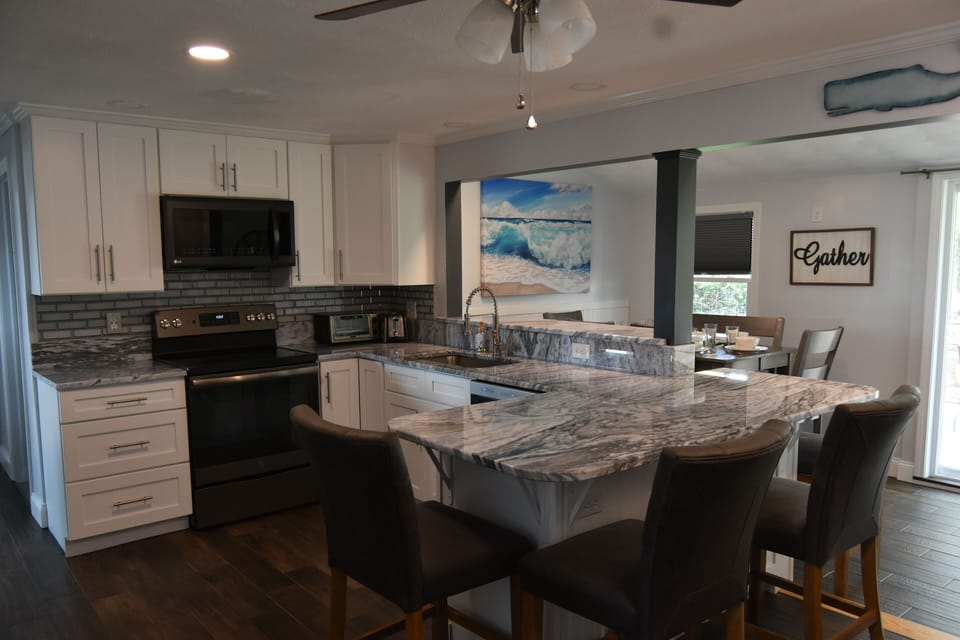 Fully stocked kitchen with enough place settings, glasses and flatware for all 