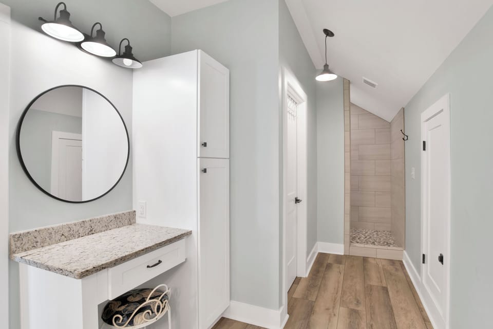 Makeup vanity and walk-in tile shower